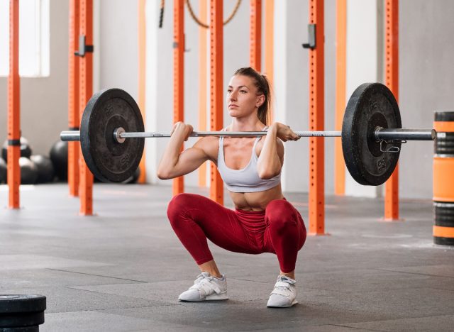 woman performing barbell front squats