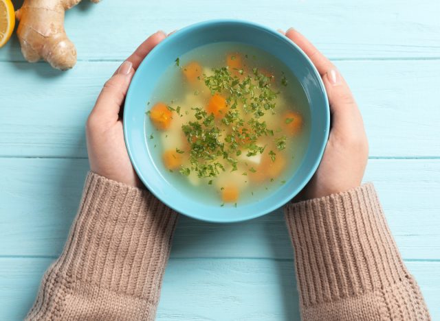 close-up of woman holding chicken soup