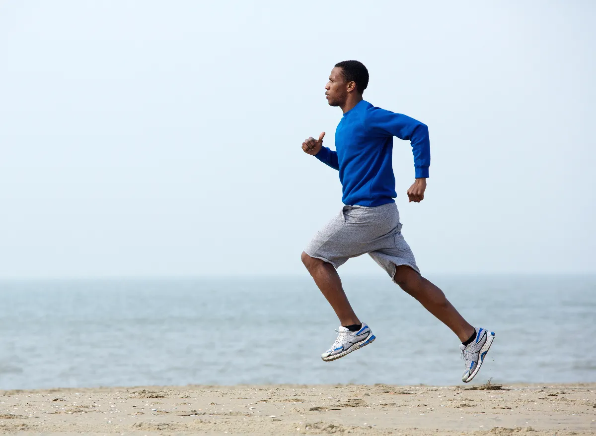 fit man demonstrating how to slim down and get toned with a 15-minute jogging workout on the beach