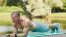 fit mature man performing plank exercises to improve muscular endurance