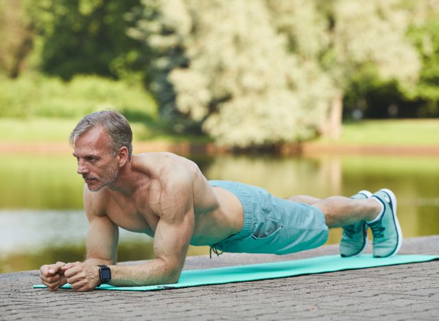 fit mature man performing plank exercises to improve muscular endurance