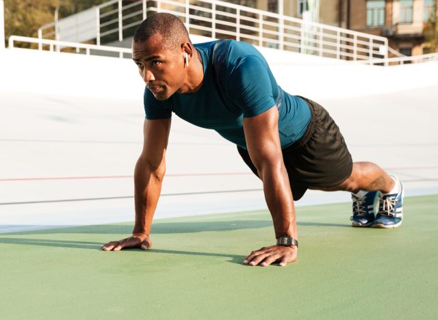 man performing pushup exercises to lose belly fat