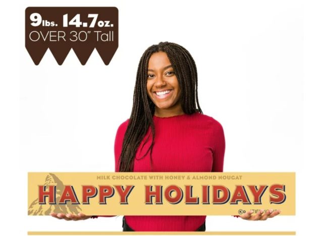 girl holding giant toblerone candy bar