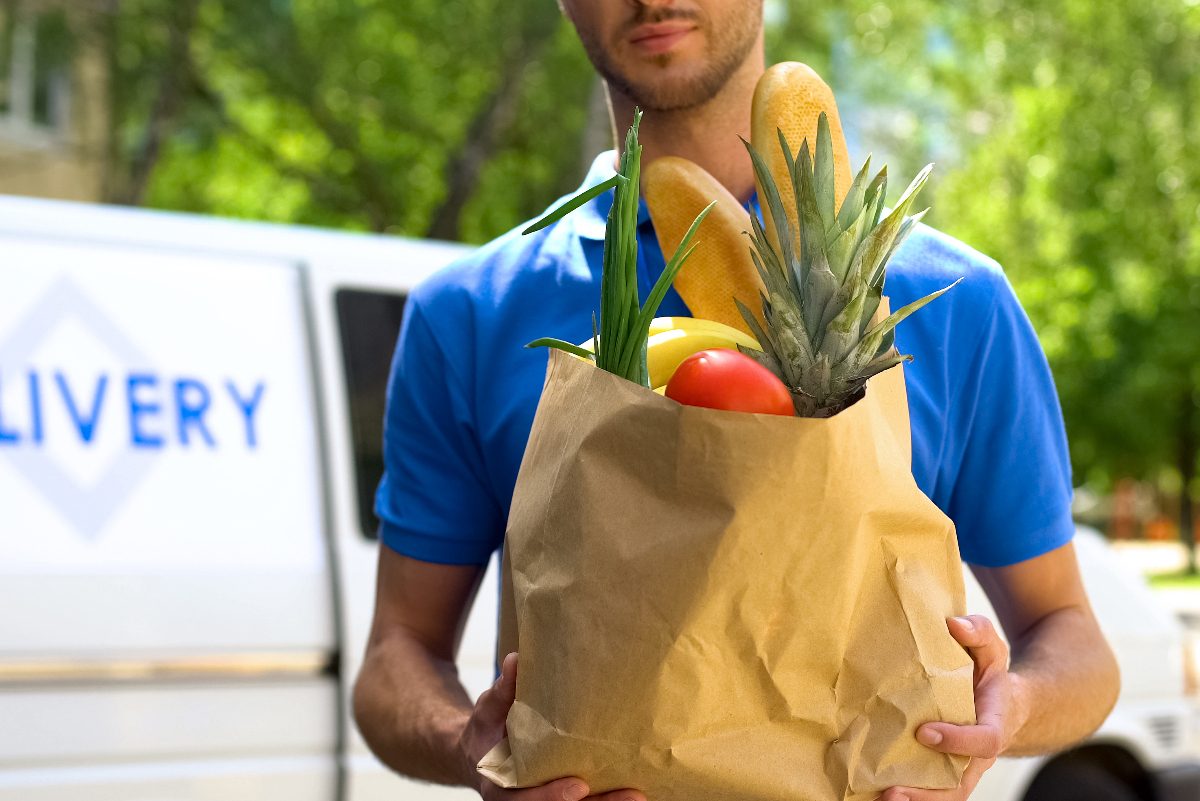 grocery delivery worker holding grocery bag
