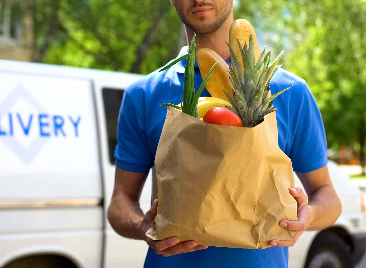 grocery delivery worker holding grocery bag