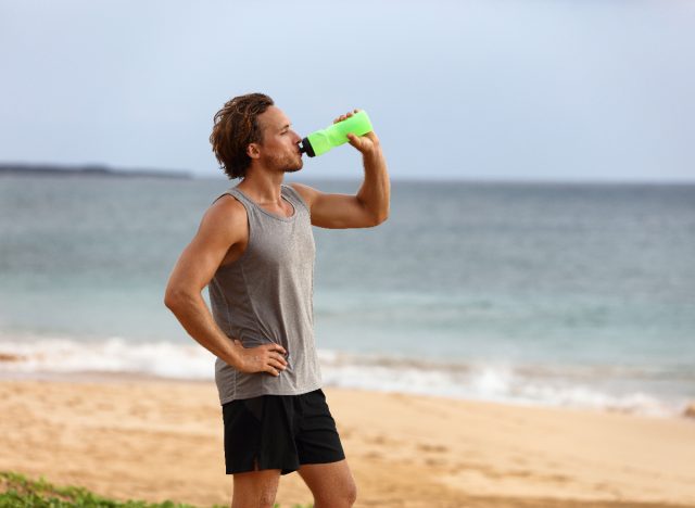 man drinking water bottle, demonstrating running tips for weight loss