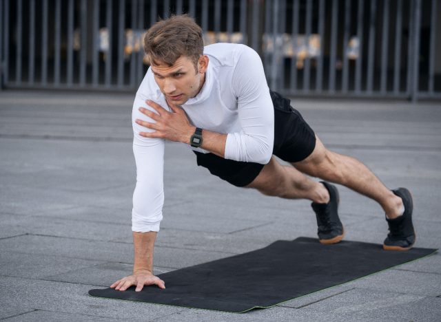 man demonstrates plank shoulder tap exercises to regain muscle mass in your arms