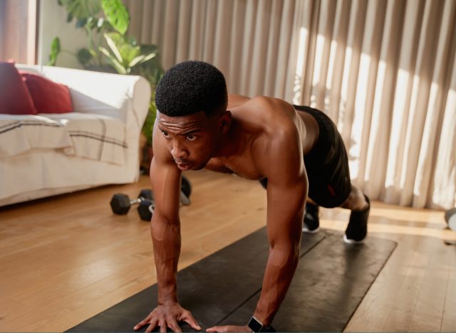 Man doing push-ups and simple exercises at home to stay in top shape