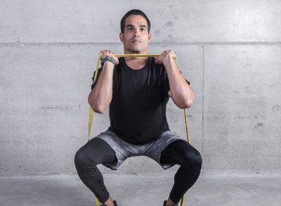 fit man demonstrating resistance band workout for weight loss