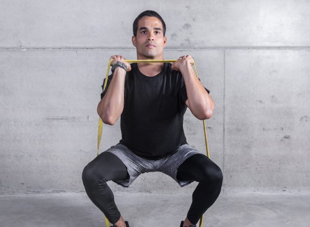 fit man doing banded thruster exercises for a fitter body after 30