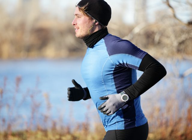 man running vigorously in the winter, demonstrating exercises men shouldn't do for weight loss