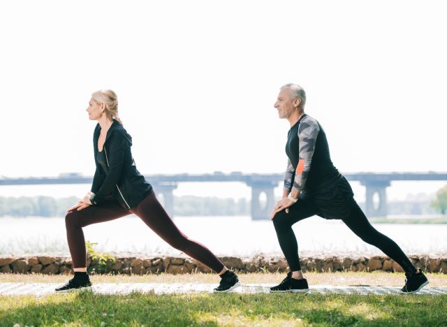 mature couple doing walking lunges
