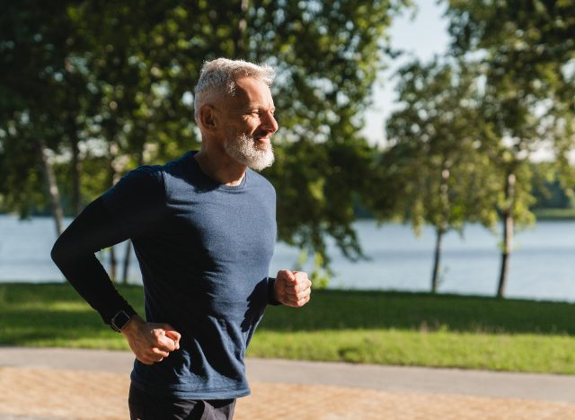 older man jogging outdoors on sunny day