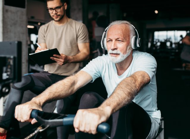 older man working out on rowing machine, demonstrating cardio exercises to keep your heart young as you age