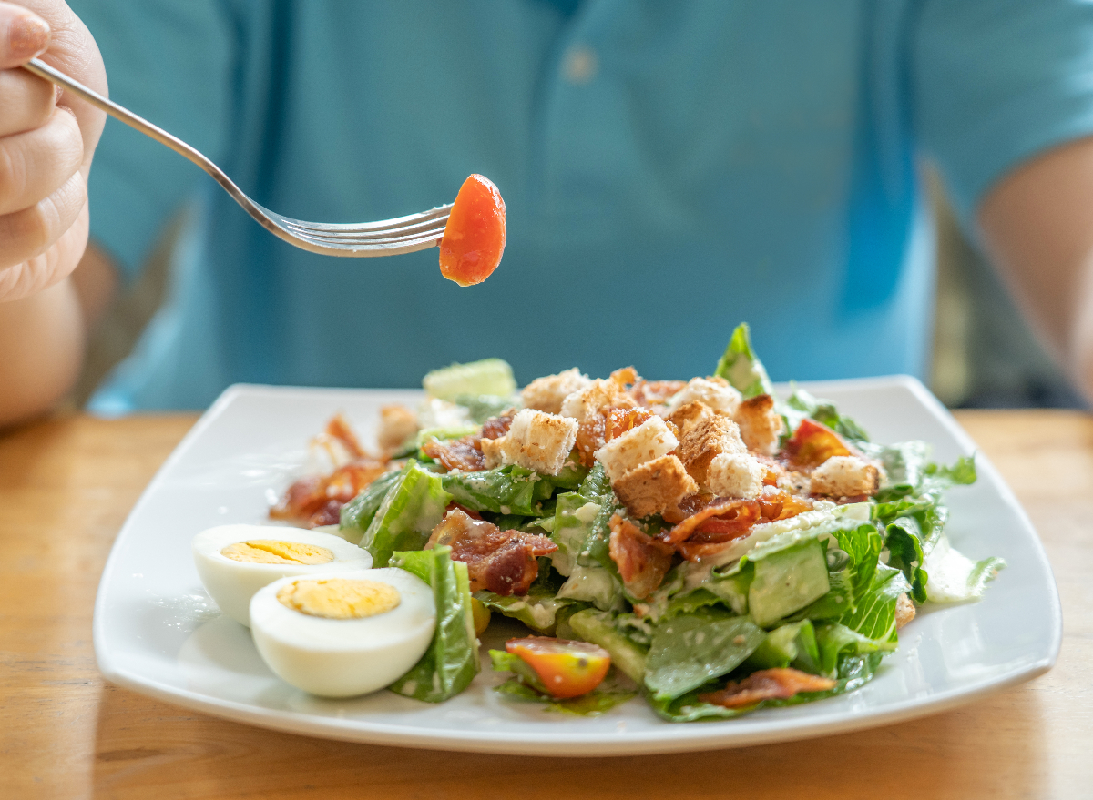 person eating caesar salad