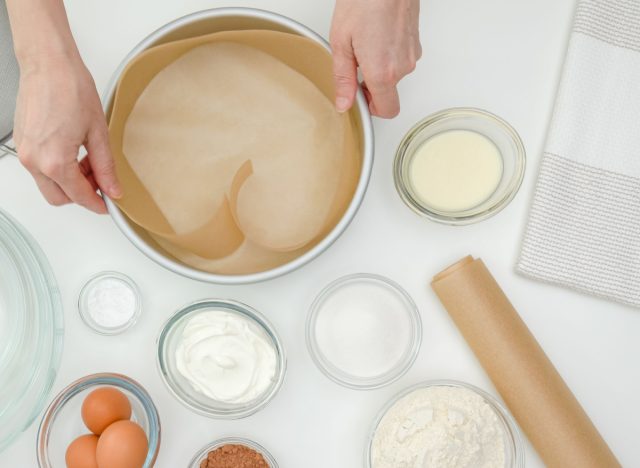 putting parchment paper into cake pan