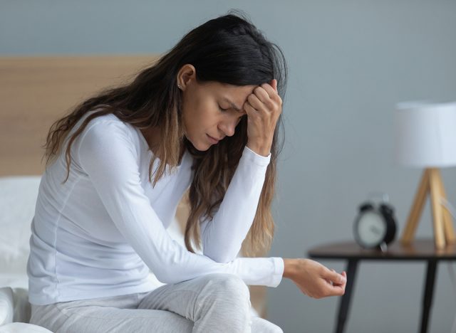 woman depressed sitting on bed