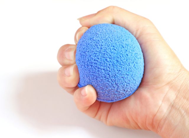 woman squeezing stress ball exercises for tennis elbow