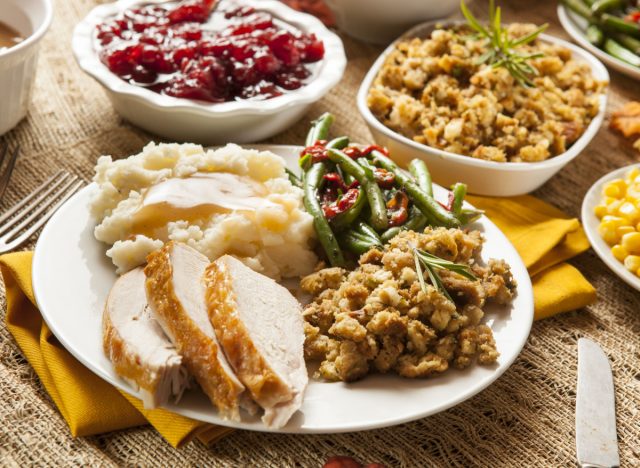 thanksgiving dinner plate with turkey, green beans, stuffing, and mashed potatoes