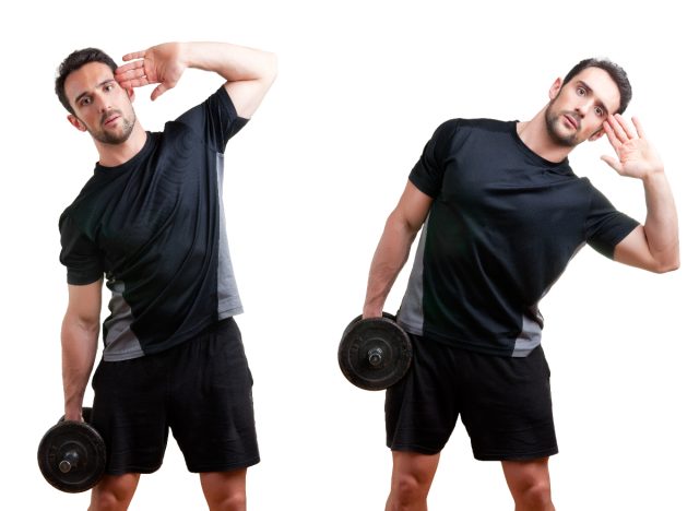 trainer demonstrating dumbbell side bends