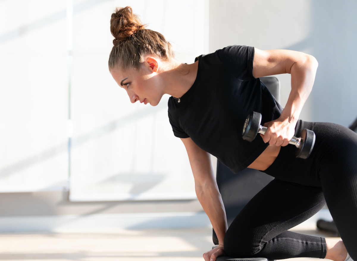 woman demonstrating at-home arm exercises for flabby triceps with dumbbell