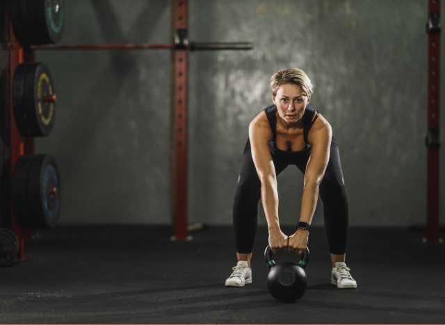 woman performing kettlebell swings