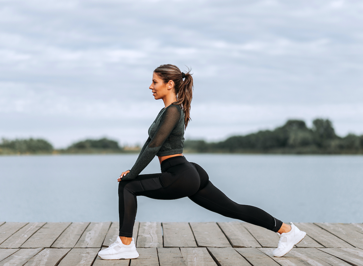 woman performing lunges on a pier, exercises for toned thighs