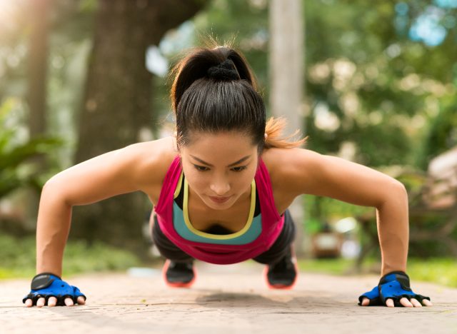 woman performing pushups outdoors