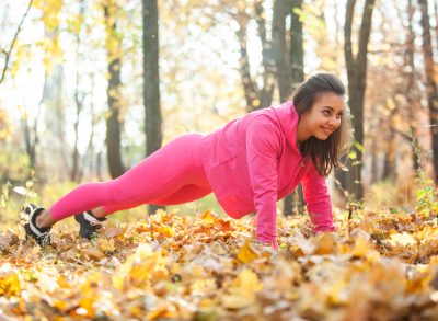 woman performing plank exercises to debloat after Thanksgiving