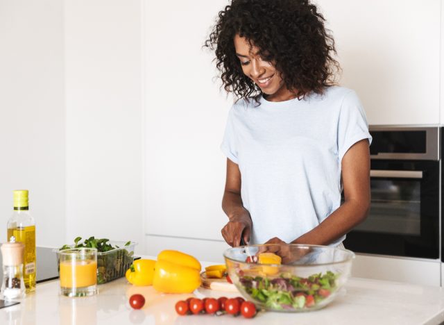 woman preparing healthy meal for weight loss, cutting calories to lose weight