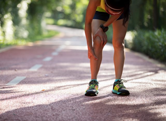 woman suffering knee pain from running on pavement