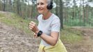 fitness woman in woods demonstrating workout for people in their 50s