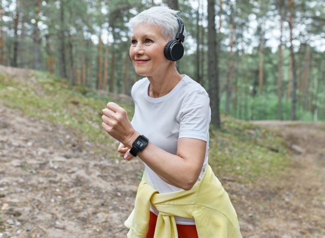 fitness woman in woods demonstrating workout for people in their 50s