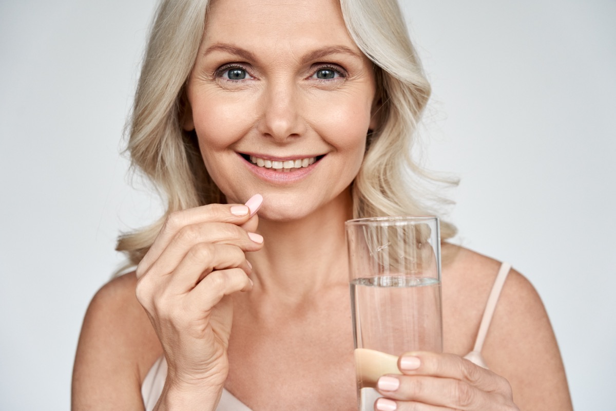 Smiling,Happy,Healthy,Middle,Aged,50s,Woman,Holding,Glass,Of