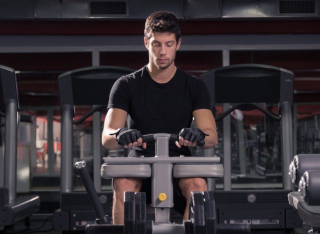 man on calf raise machine at gym