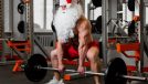 fitness man at the gym with barbell, holiday workout Christmas workout songs concept