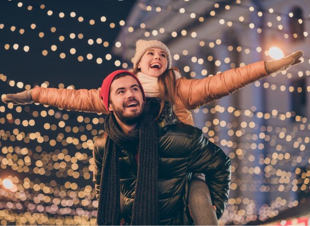 happy couple looking at christmas lights display