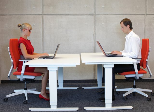 desk chair posture concept, two people working at desk in desk chairs, age-proof your back