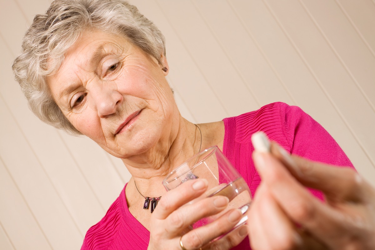 Senior,Mature,Lady,Holding,A,Tablet,Or,Pill,In,One
