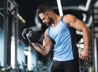 man working out with dumbbells, demonstrating how to increase muscle power