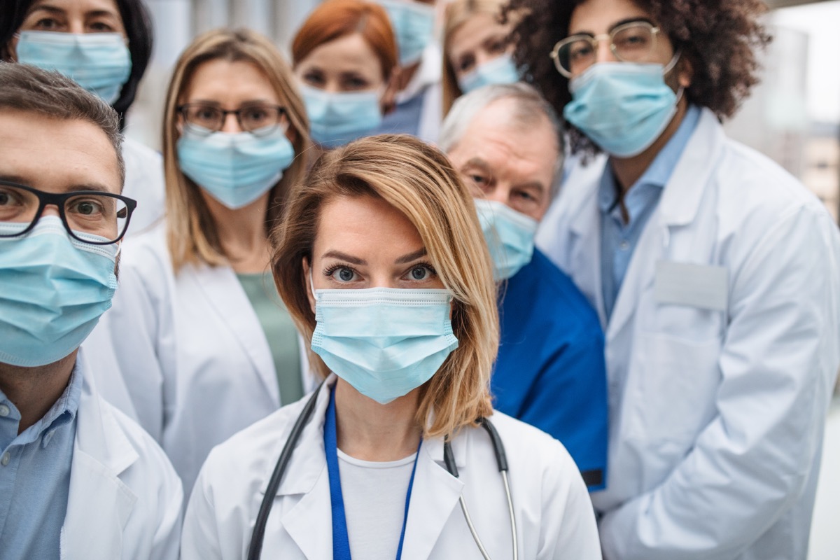 Group,Of,Doctors,With,Face,Masks,Looking,At,Camera,,Corona