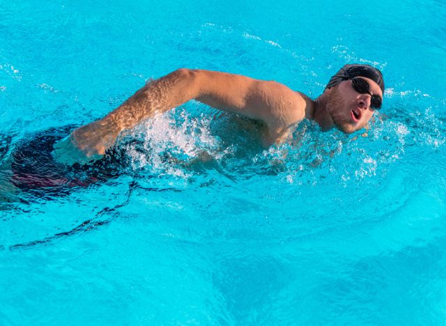 fit man swimming laps for low-impact workout