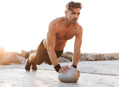 fitness man doing stability ball pushups to build a stronger upper body