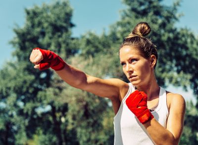 fitness woman doing boxing jab for one-month weight loss challenge