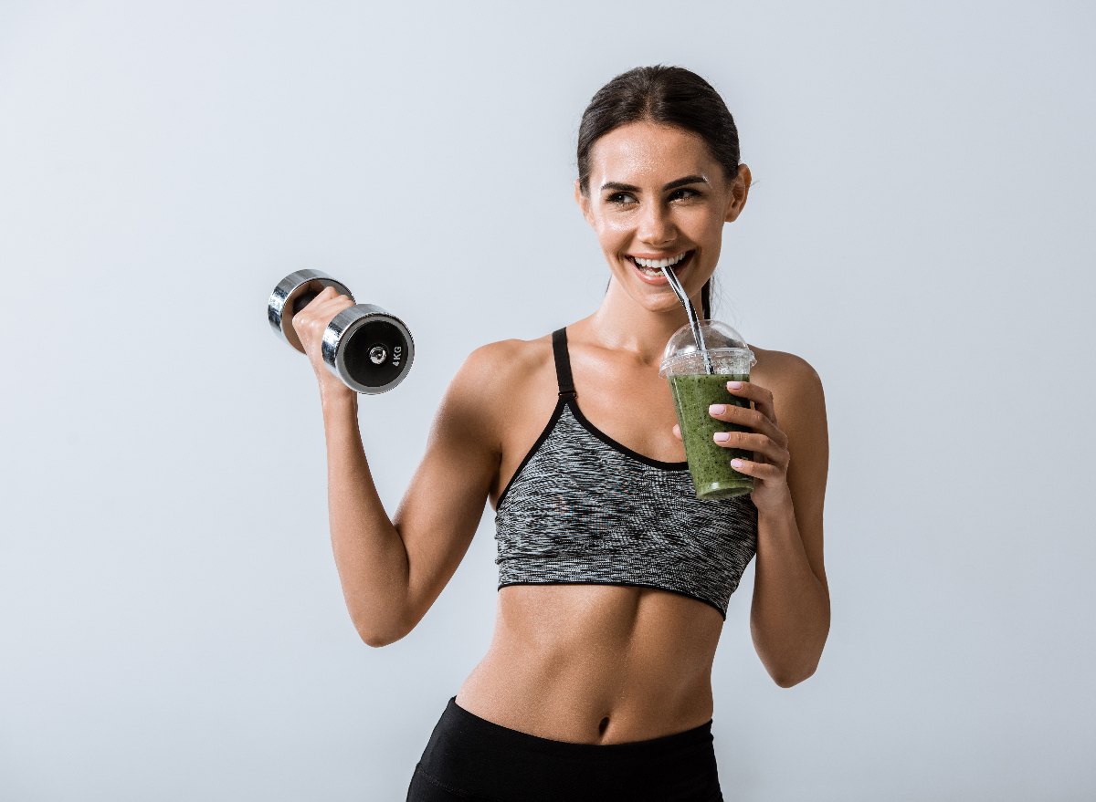 fitness woman holding dumbbell and smoothie, concept of how to keep the weight off long-term