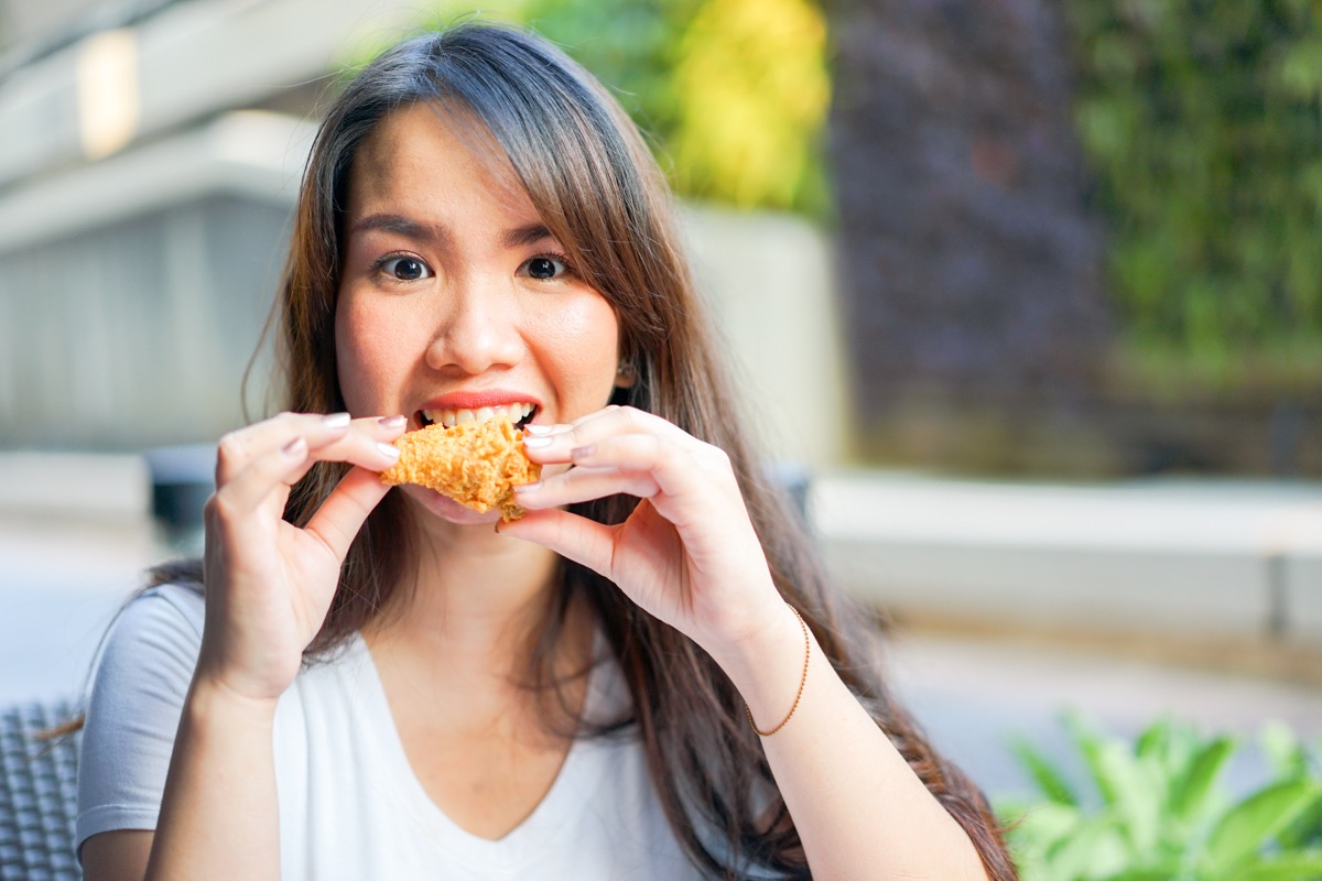 Close,Up,Young,Pretty,Asian,Woman,Opening,Mouth,And,Holding