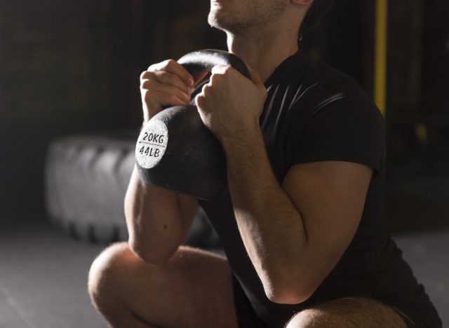 man demonstrating kettlebell goblet squat exercises for chicken legs