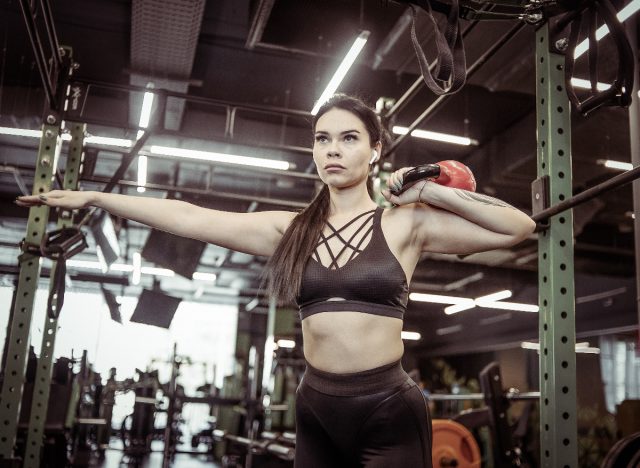 woman doing kettlebell push press exercise