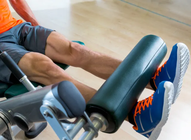 leg extension machine, man demonstrating how to regain muscle mass in your legs through machine exercises