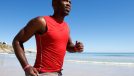 man running on beach, demonstrating how to get rid of moobs with cardio